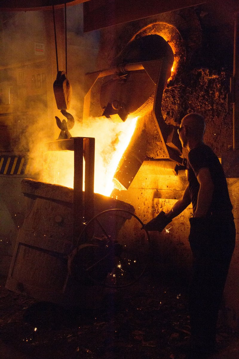 Industrial smelter operation with molten metal processing and emissions control infrastructure